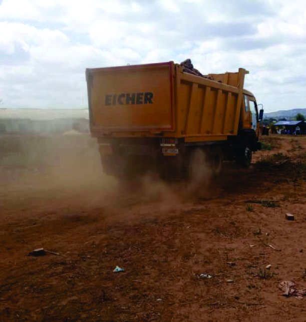 Tipper truck discharging a load of material on site.